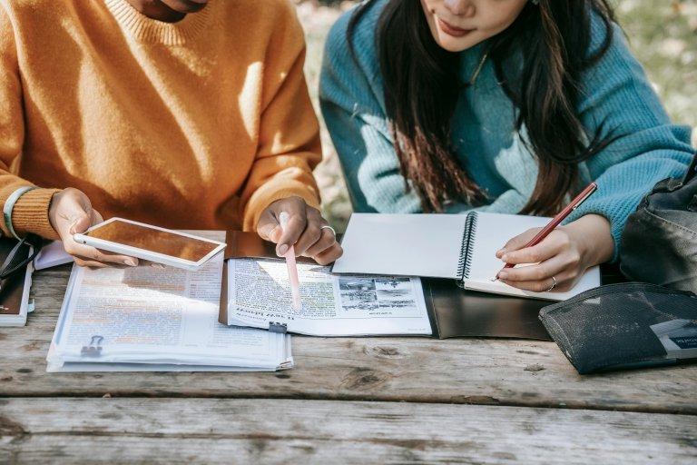 Two students studying outside. 